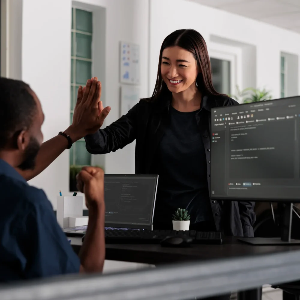 happy-system-engineers-celebrating-successful-code-2023-11-27-04-57-37-utc